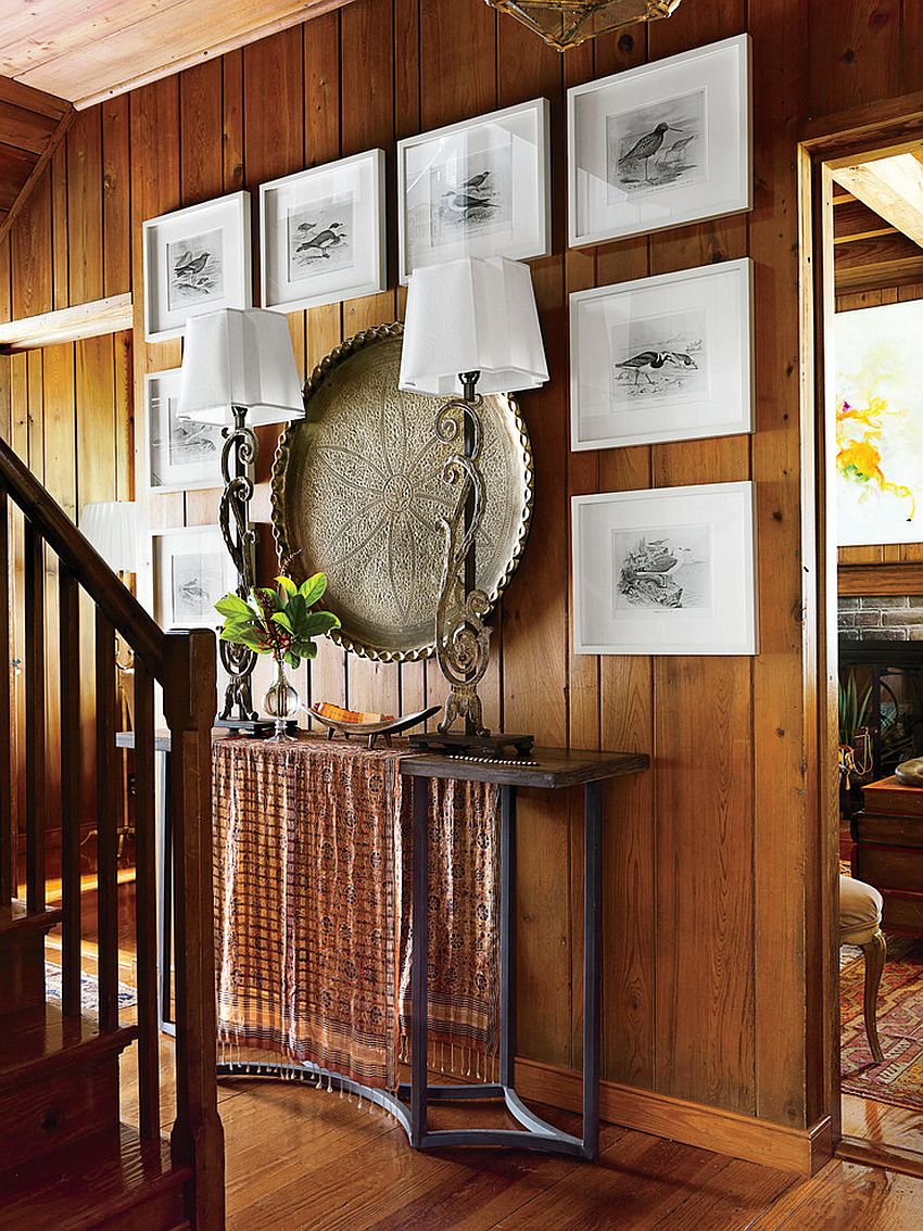 Seabird engravings framed in white coupled with large brass Indian plate create a stunning entry wall