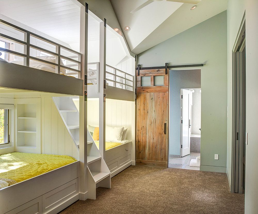 Sliding barn door in the kids' room with wall of bunk beds is a space-saver