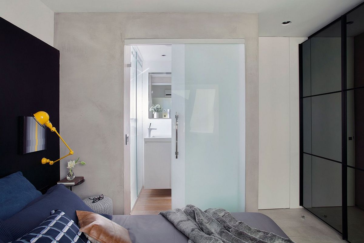 Sliding translucent glass door separates the bathroom from the bedroom