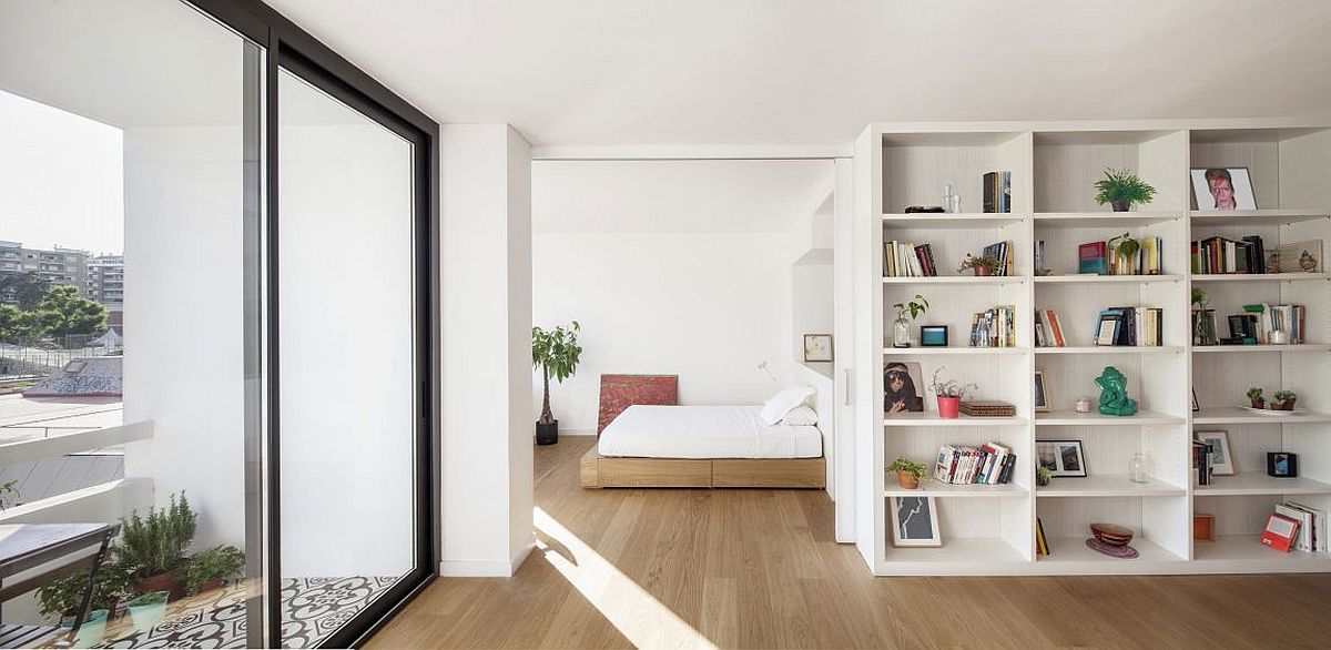 Small balcony and large glass doors bring in plenty of light into the apartment