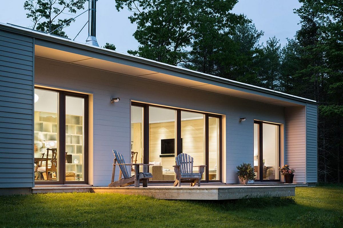 Small deck stretching out from the house offers lovely view of the pine forest