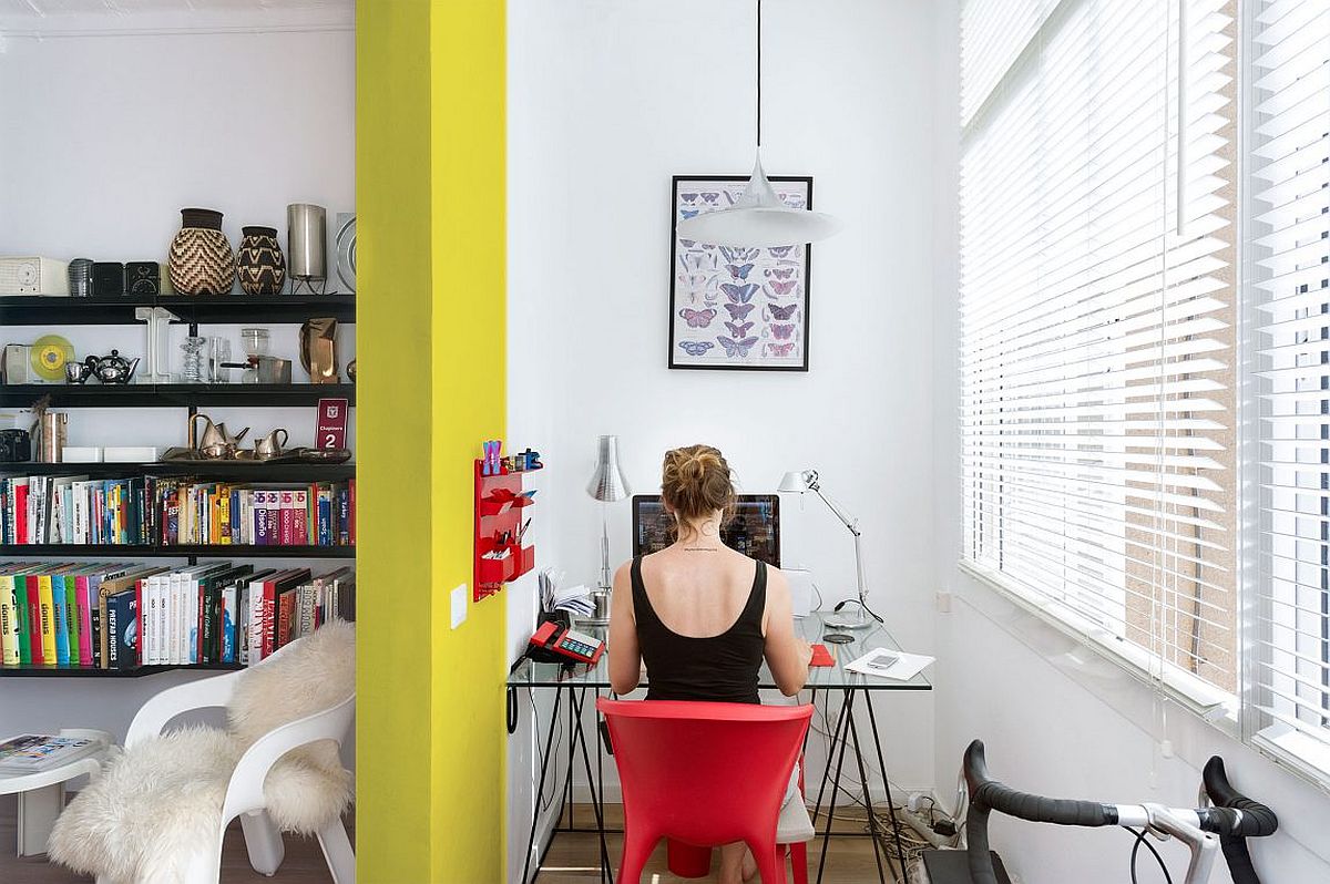 Small home workspace with ample natural light and glas desk