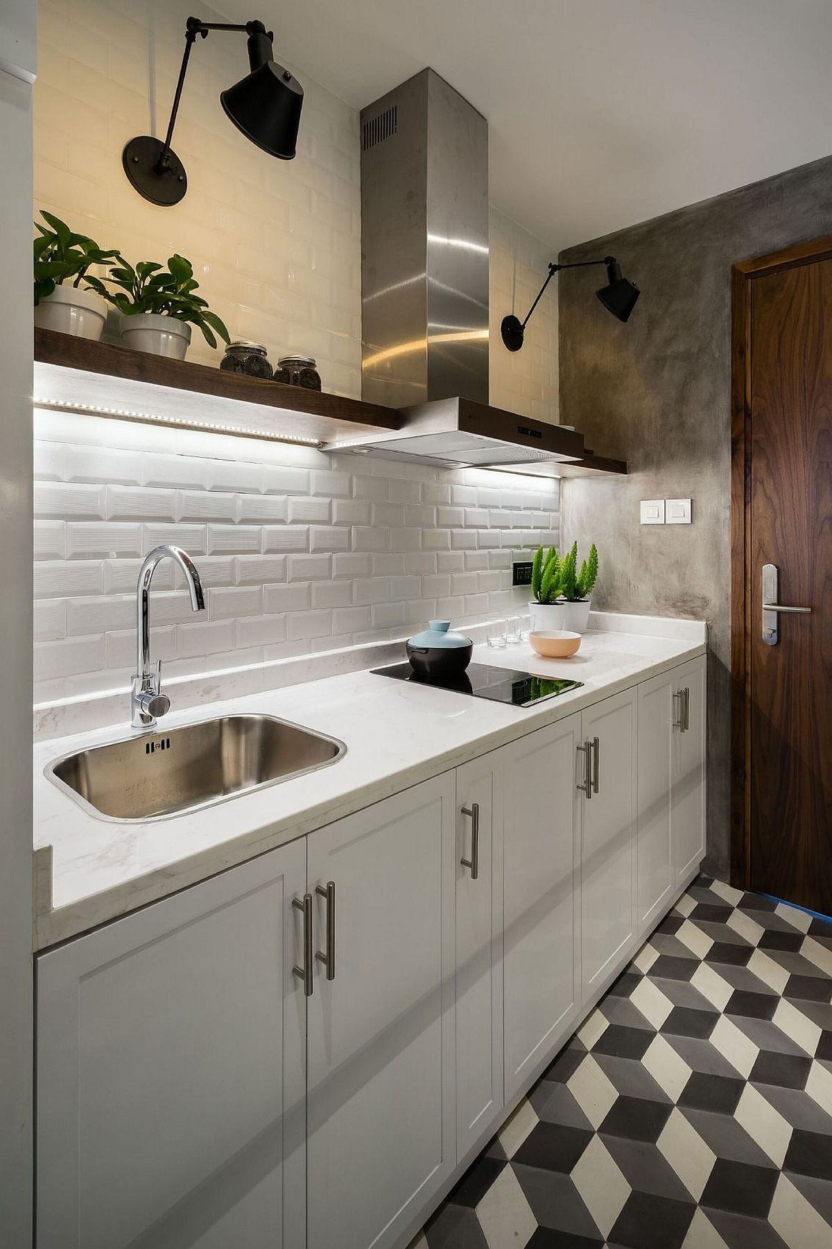 Small kitchen with white tiles and under cabinet lighting