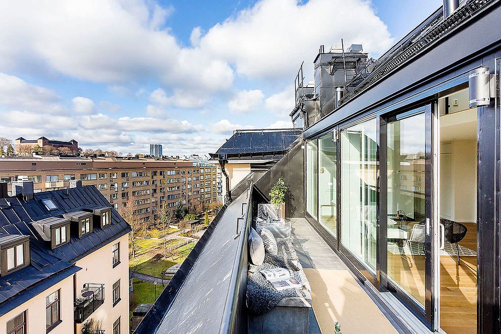 Spacious balcony of the Stockholm apartment with a view of the city skyline