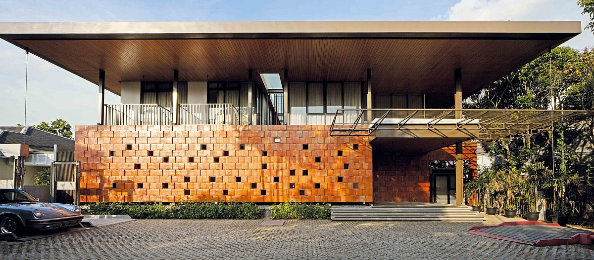 Terracotta street facade of the Jakarta home with holes that let in sunlight