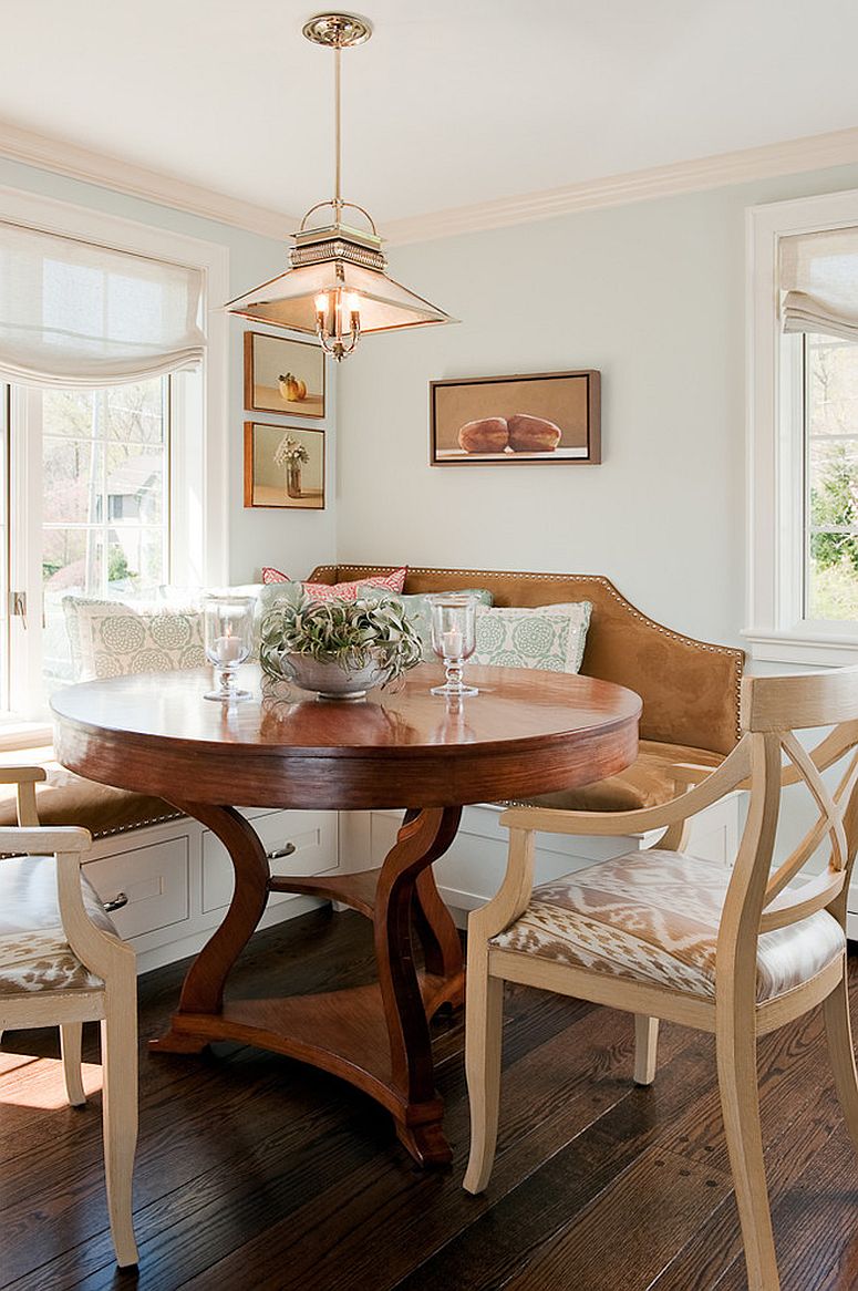 Traditional banquette in the kitchen corner with large, round wooden table