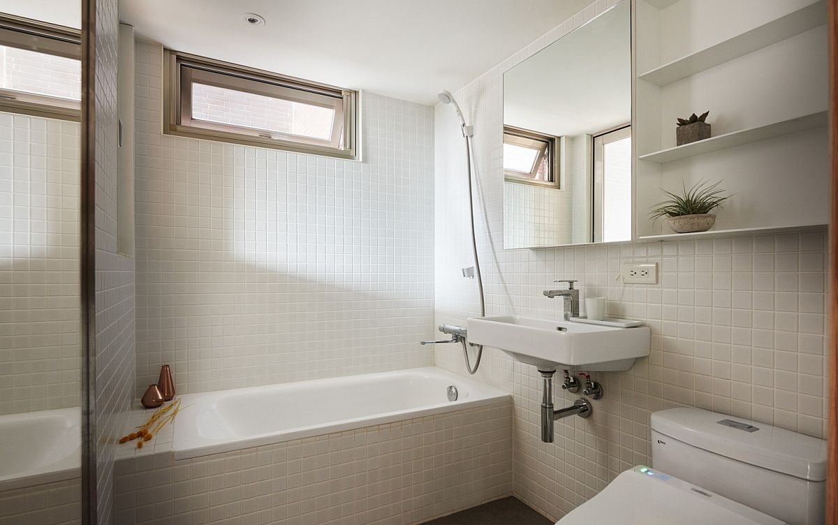 White tiles and natural light give the bathroom a spacious and airy appeal