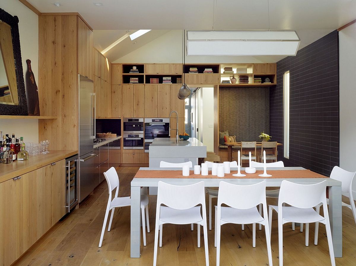 Wooden surfaces give the modern kitchen and dining a mellow, traditional vibe
