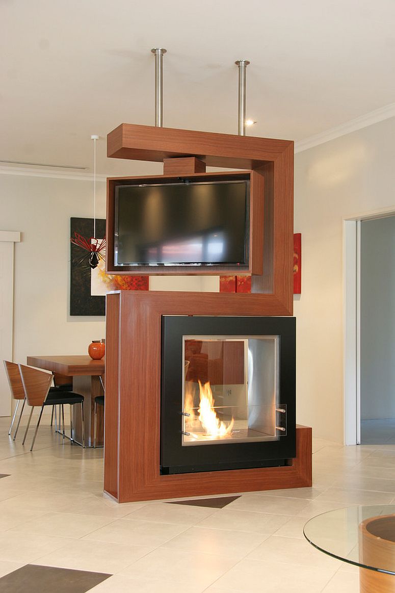 Awesome room divider holds turnable TV and fireplace