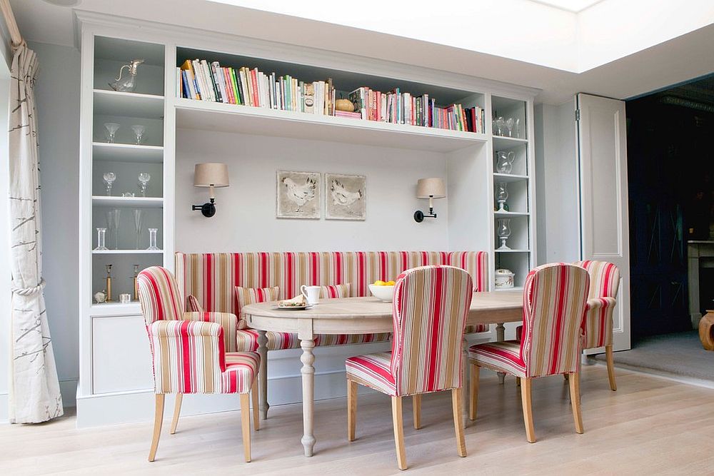 Banquette seating for the Scandinavian dining space with smart shelves all around and colorful chairs