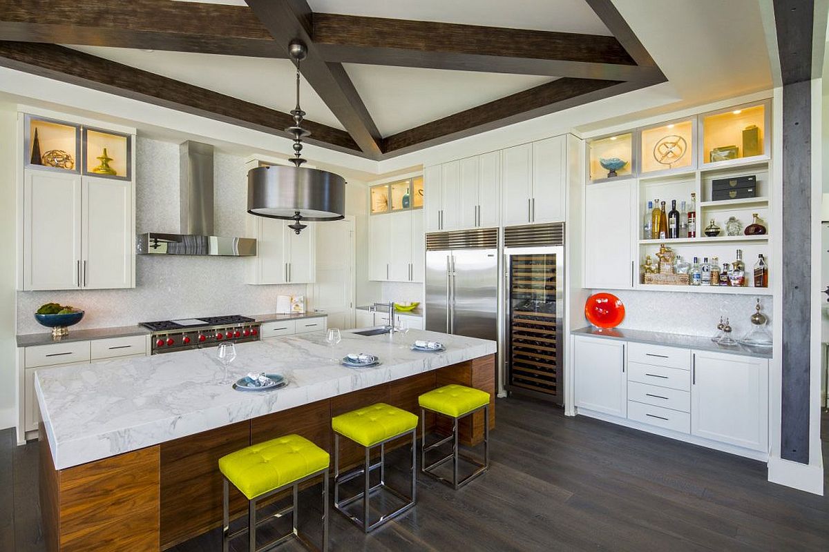 Bar stools bring yellow to the modern kitchen featuring smart marble-top island