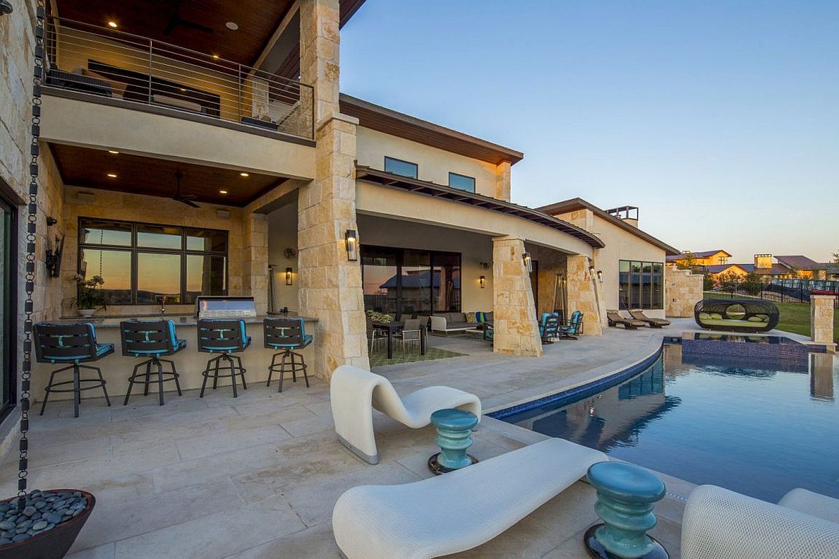 Barbeque zone, deck and pool area of the contemporary Austin home