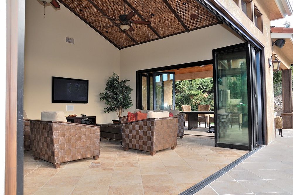 Bifolding stackable doors open up the serene sunroom to the patio outside