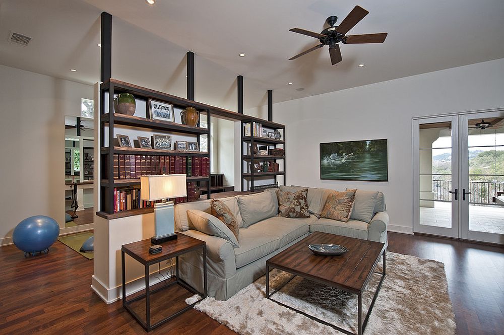Bookshelf room divider with half wall offers ample display space [Design: Bulhon Design Associates]