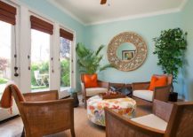 Colorful-tropical-sunroom-with-pops-of-orange-and-a-gentle-blue-backdrop-217x155