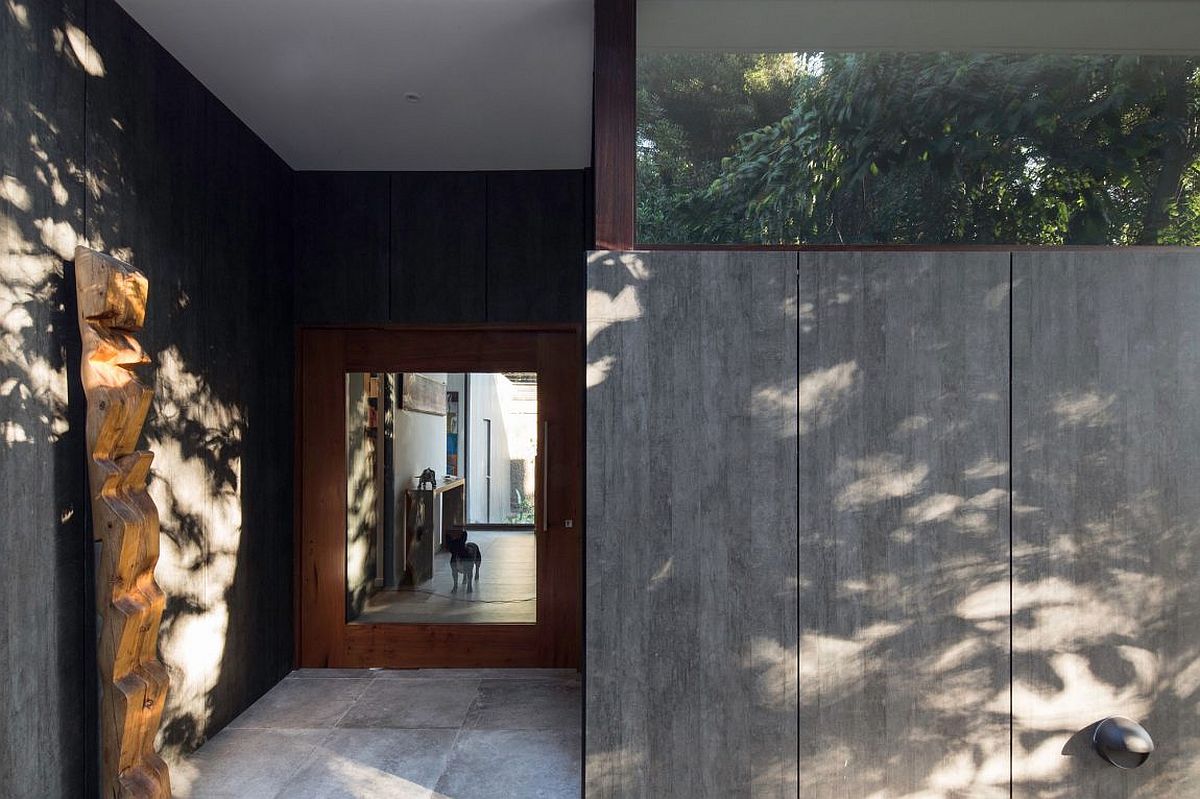 Concrete and metal shape the entrance of the distinct home