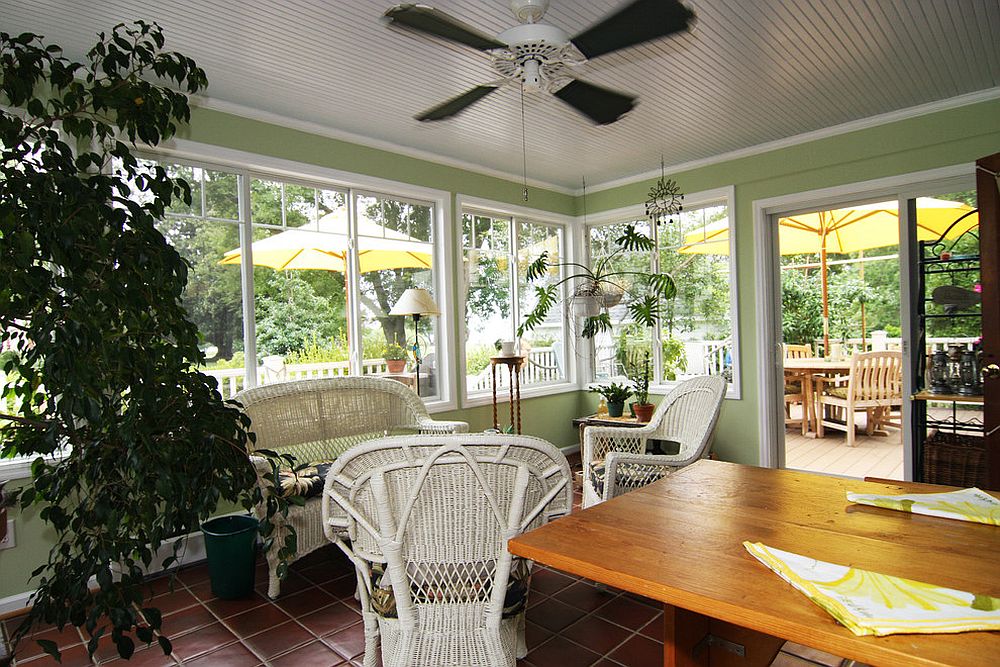 Cozy and elegant sunroom filled with green goodness and a natural vibe