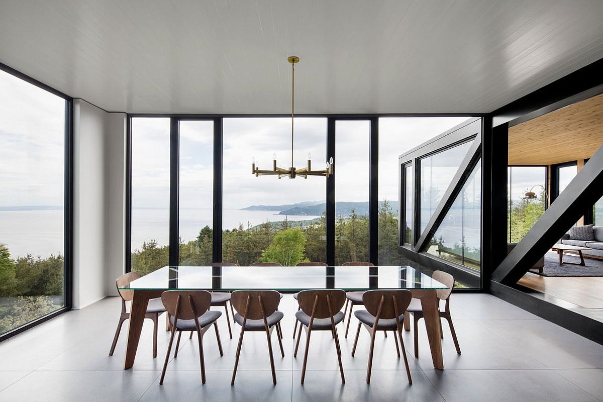 Dining room with cape views and glass walls exudes a sense of minimalism