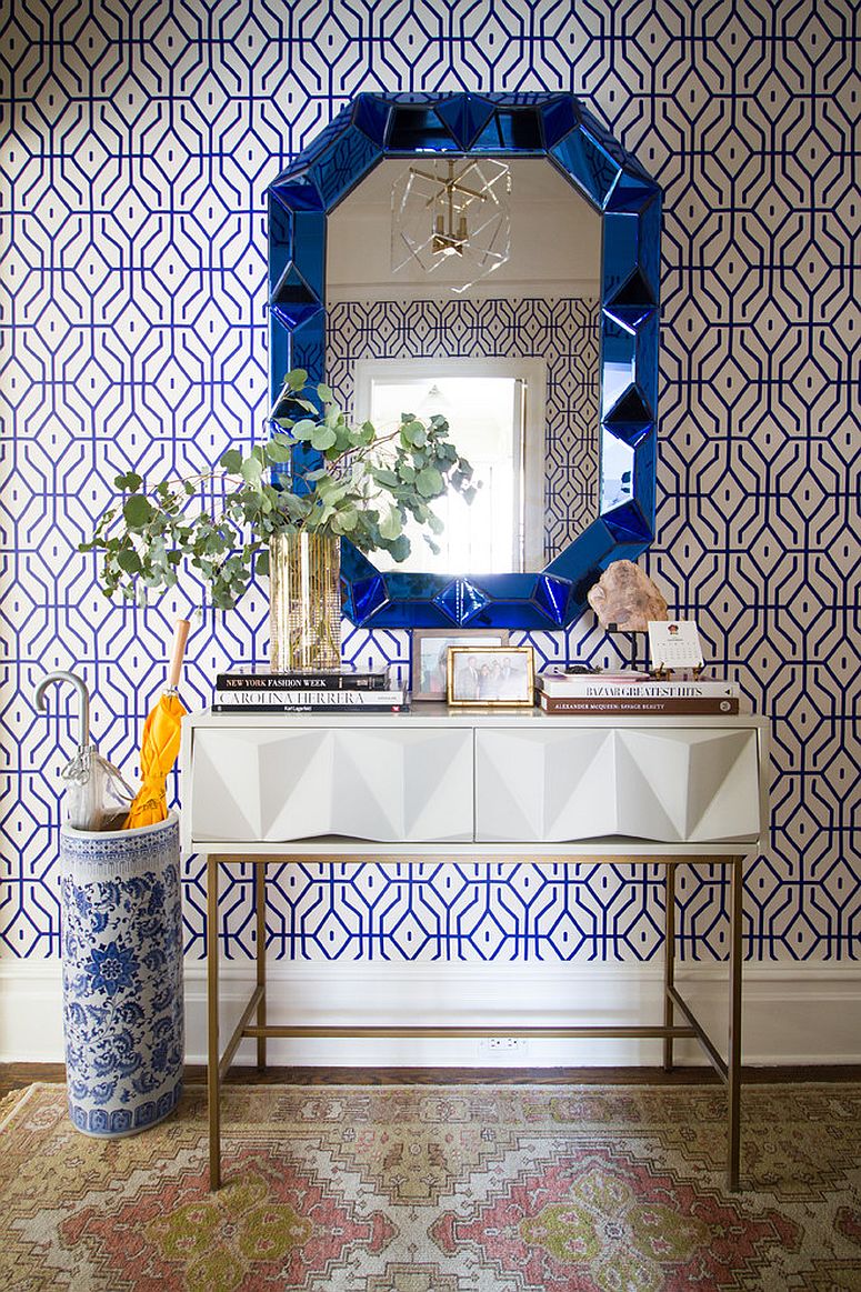 Entry of charming New York home with fabulous wallpaper, mirror and console