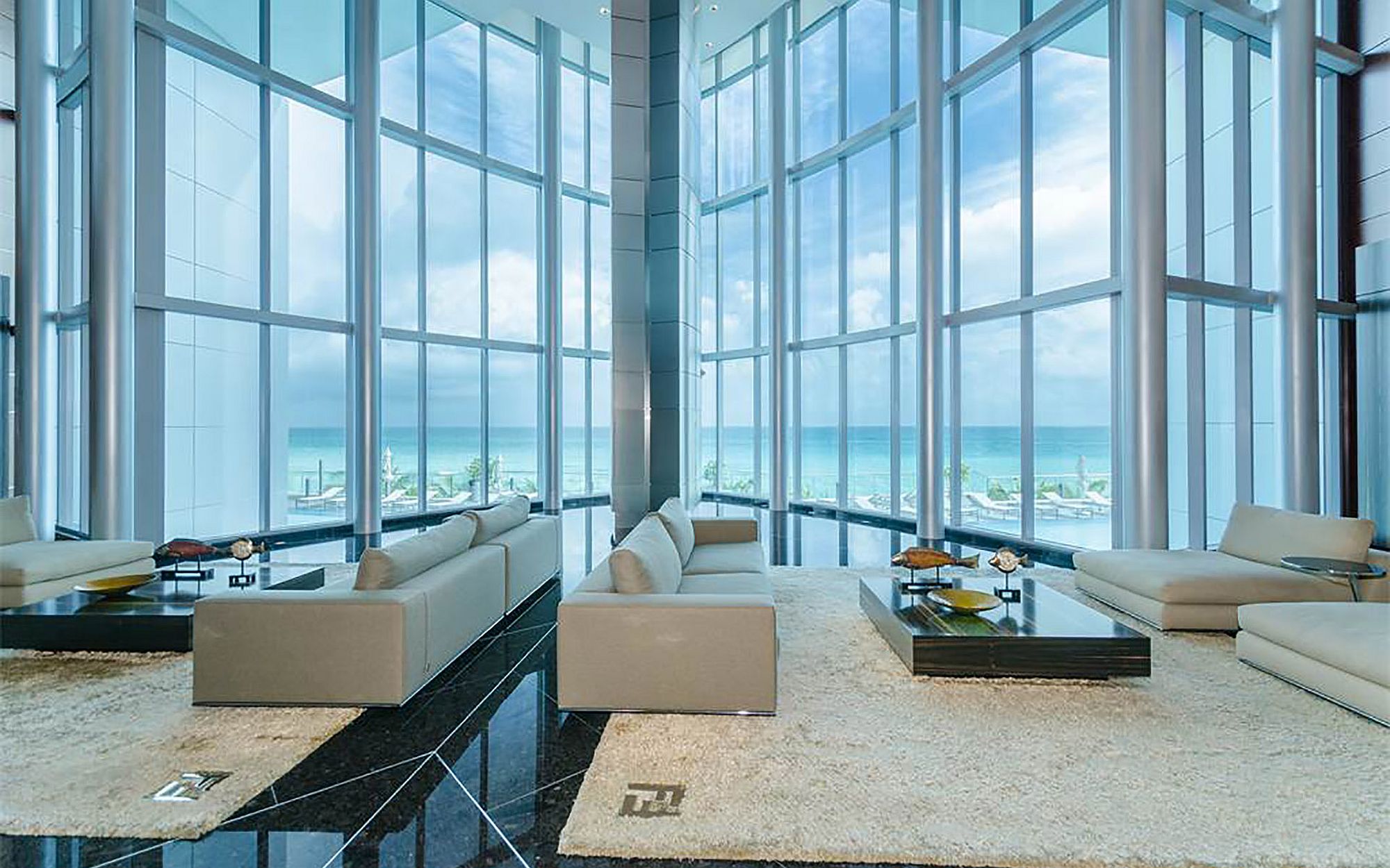 Expansive and awesome living room with glass walls and ocean views