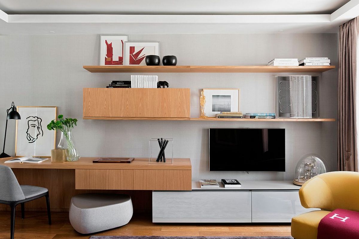 Floating wooden shelves and cabinets make use of corner in the living room