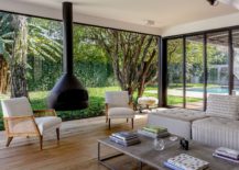 Glass-walls-and-sliding-glass-doors-bring-the-garden-outside-indoors-217x155