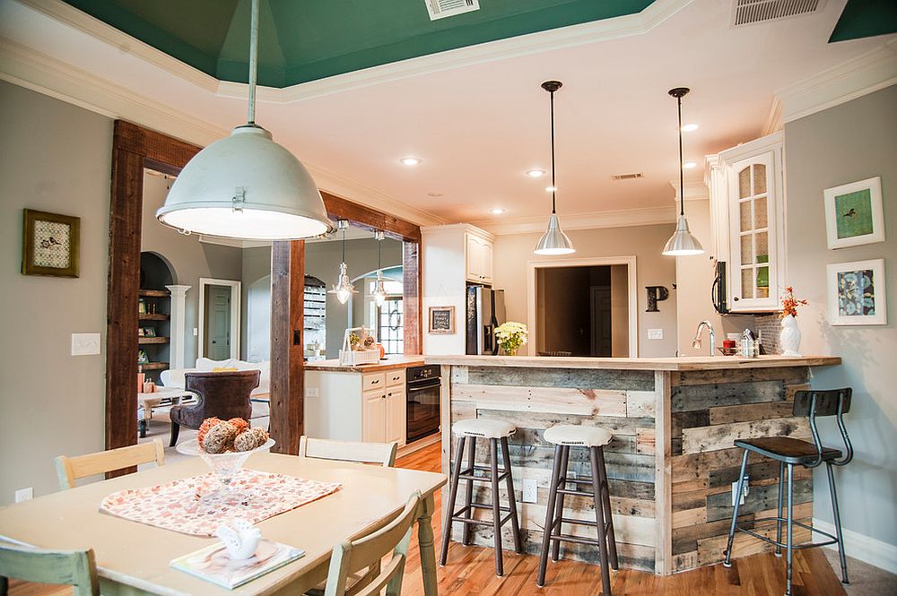 Gorgeous planks of reclaimed wood give the kitchen island and breakfast zone a unique character