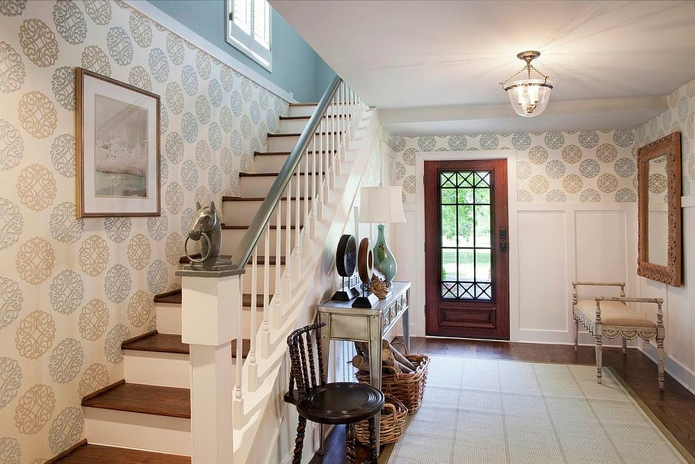 Graphic wallpaper and neutral color scheme links the entryway with the rest of the home [Design: Eric Ross Interiors, LLC]