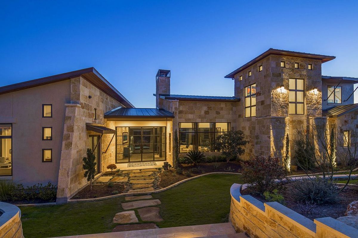 Landscape lighting adds to the elegance of the modern rustic Texas home