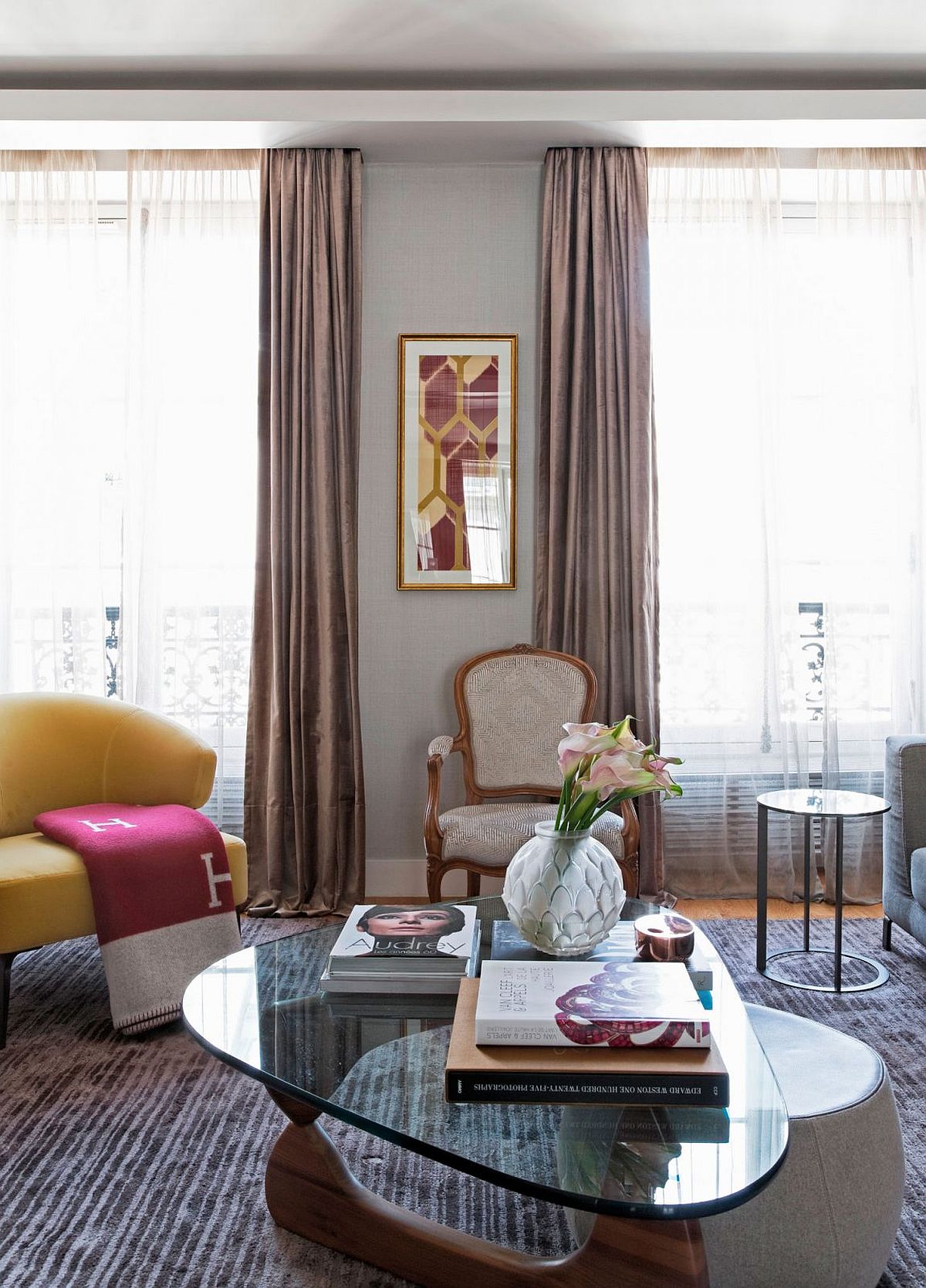 Large, classic windows bring in ample natural light into the Paris apartment