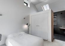 Large-wardrobe-serves-as-a-room-divider-between-the-attic-bedroom-and-bathroom-217x155