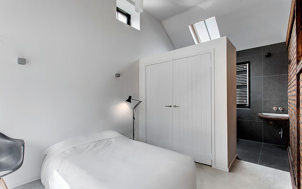 Large wardrobe serves as a room divider between the attic bedroom and bathroom