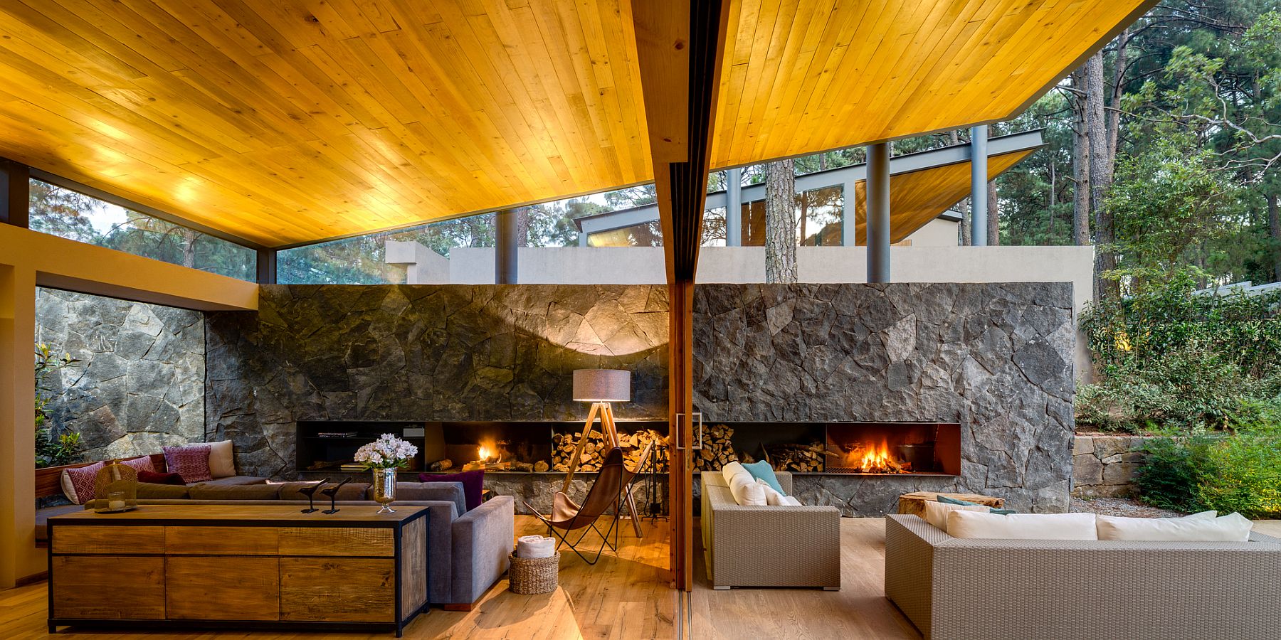 Living area and terrace with individual fireplaces separated by sliding glass doors