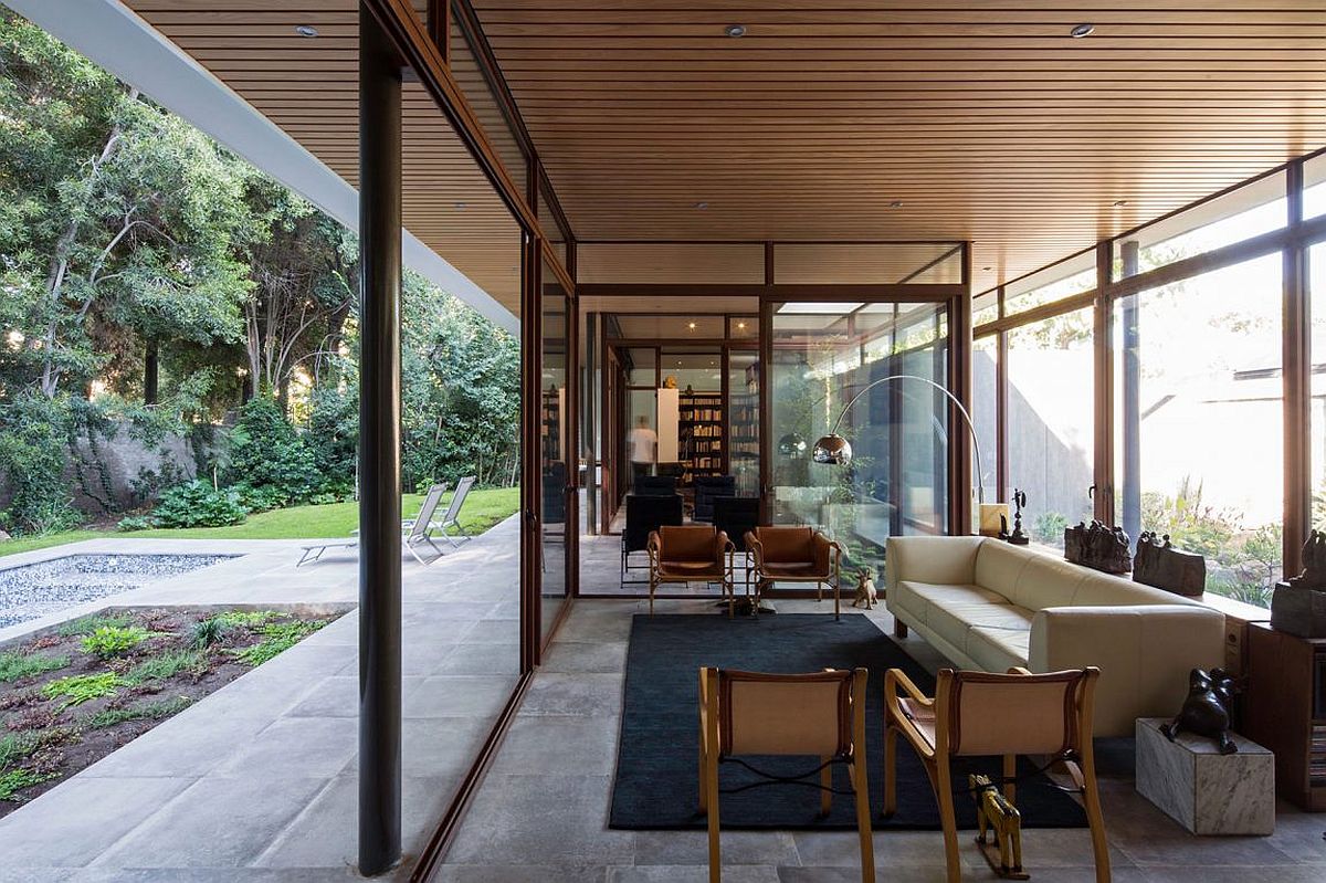 Living room with glass walls next to the garden