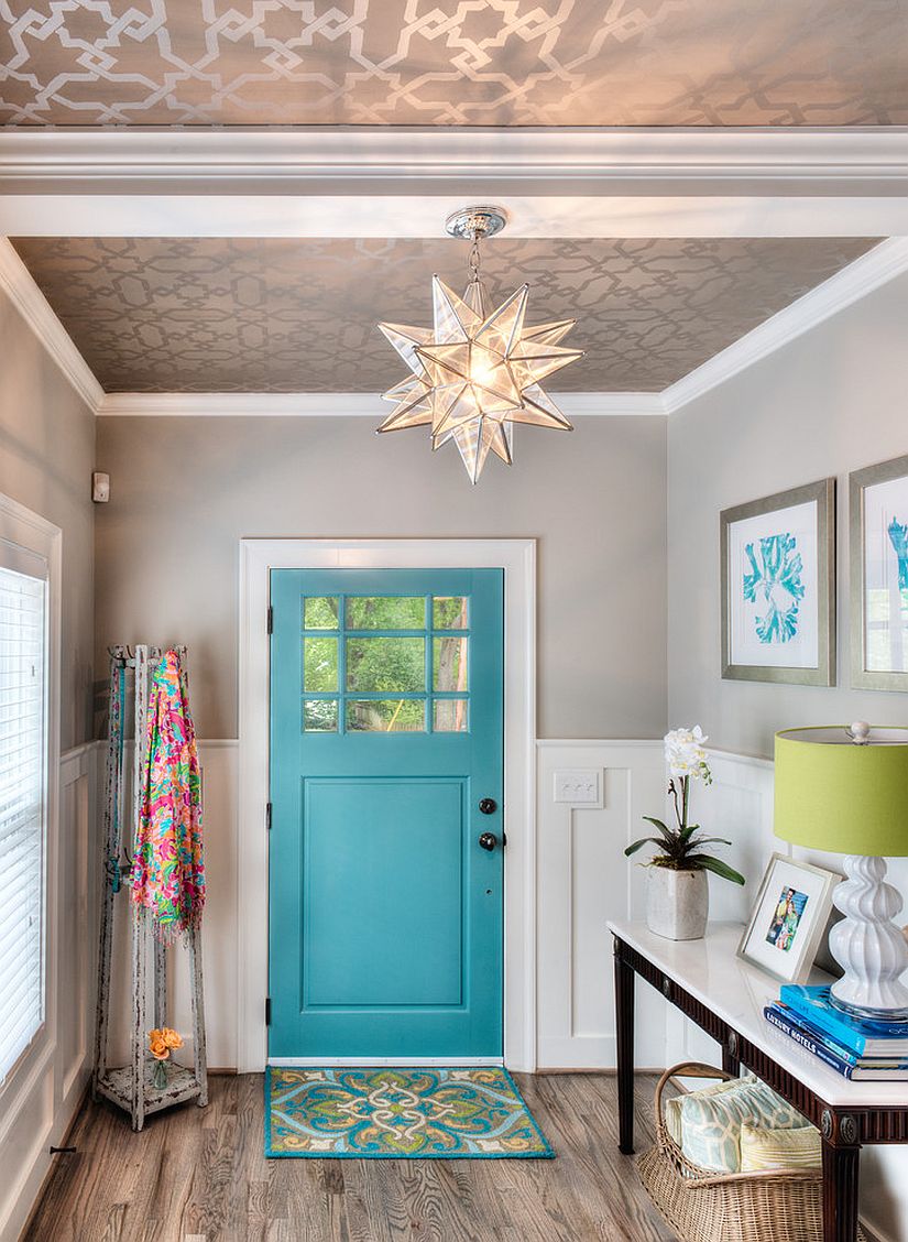 Metallic wallpaper on the ceiling and a splash of blue aim to bring Mediterranean charm to this modern entryway