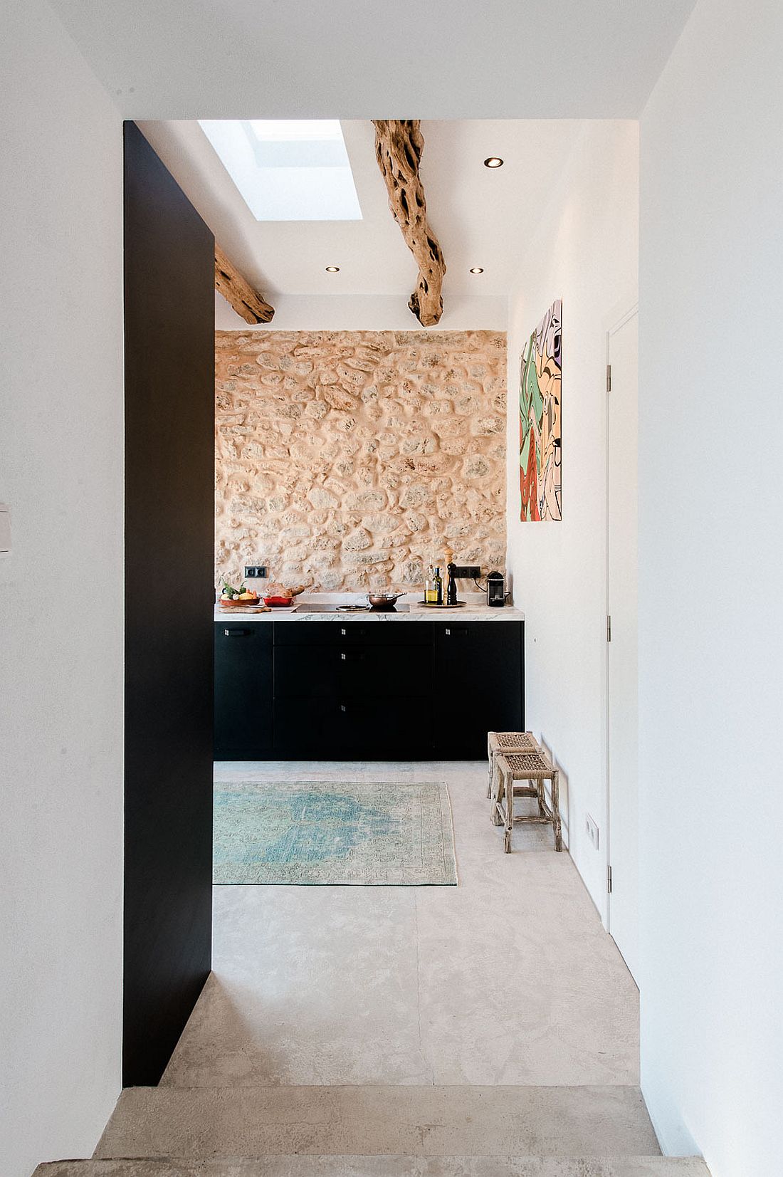 Original stone walls and timber beams in the kitchen