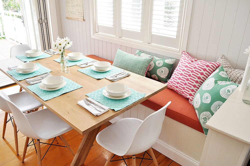 Pillows add color to the beautiful banquette dining space [Design: Greenwood's Home]