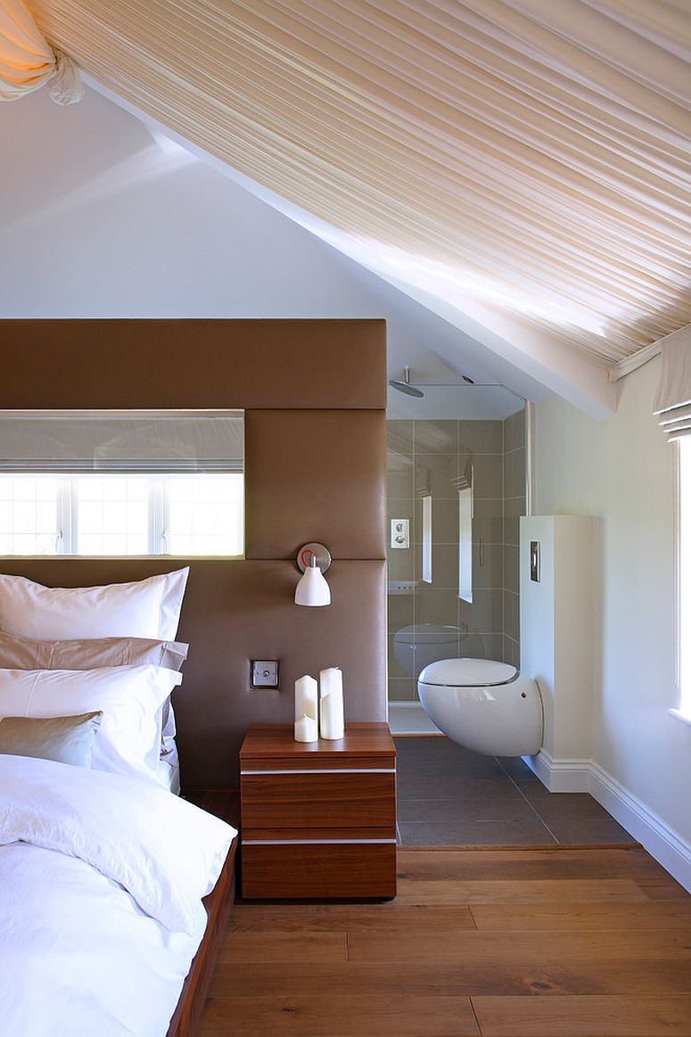 Plush headboard acts as a divider between the bedroom and the master bath