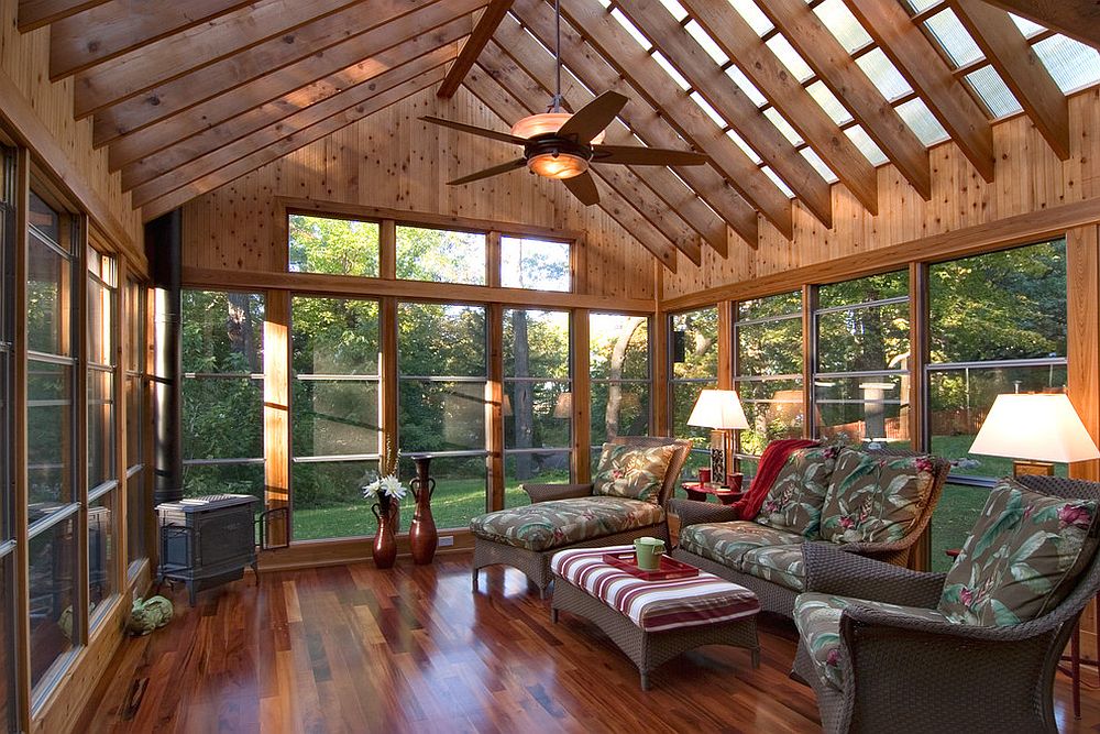 Polycarbonate roof panels flood the sunroom with filtered natural light