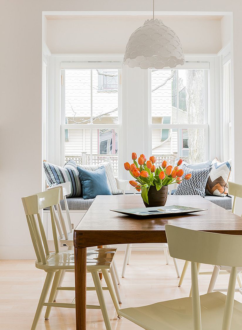 Relaxing banquette next to the window for the Scandinavian dining room