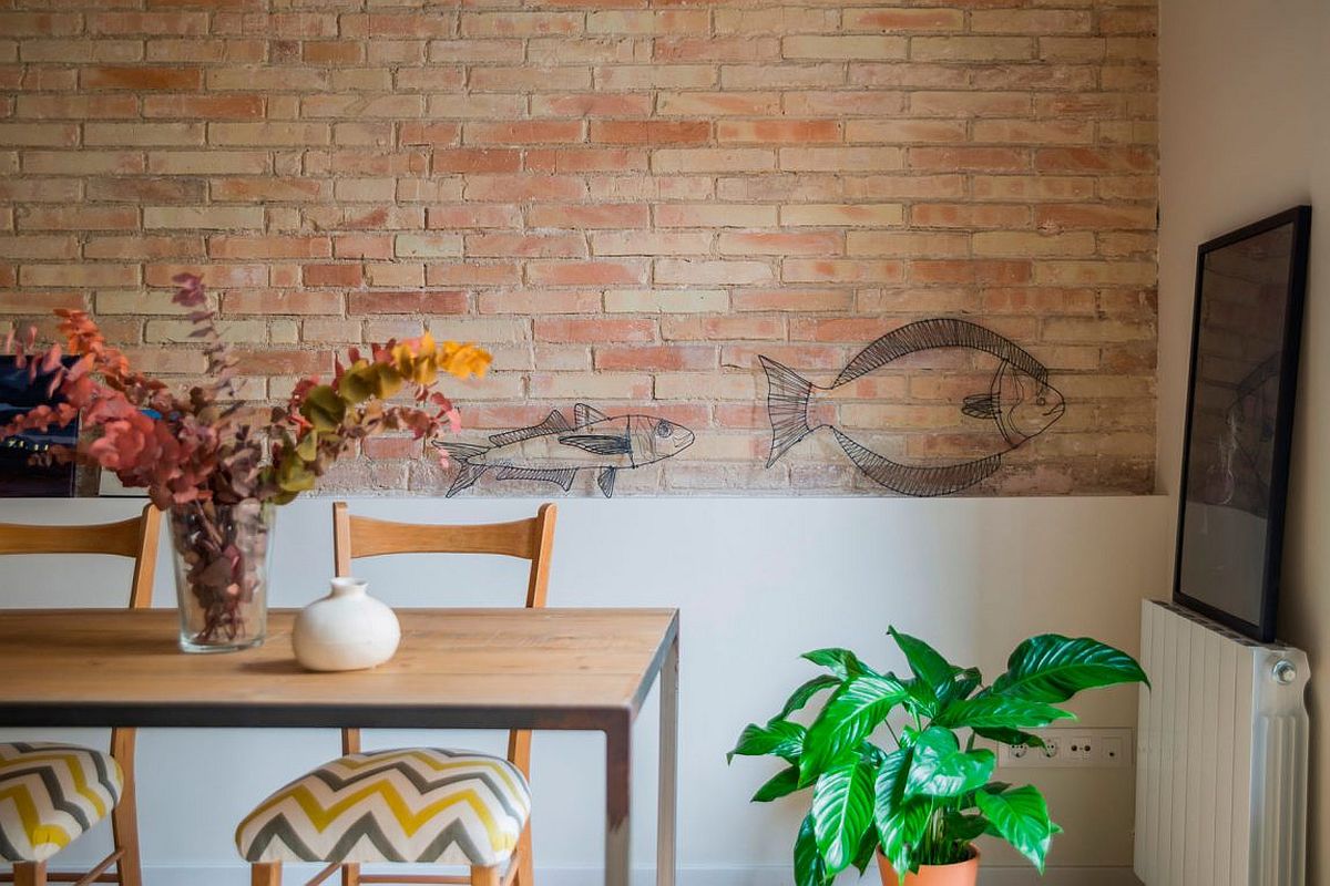 Restored and exposed brick walls add artistic value to the renovated home in Eixample District