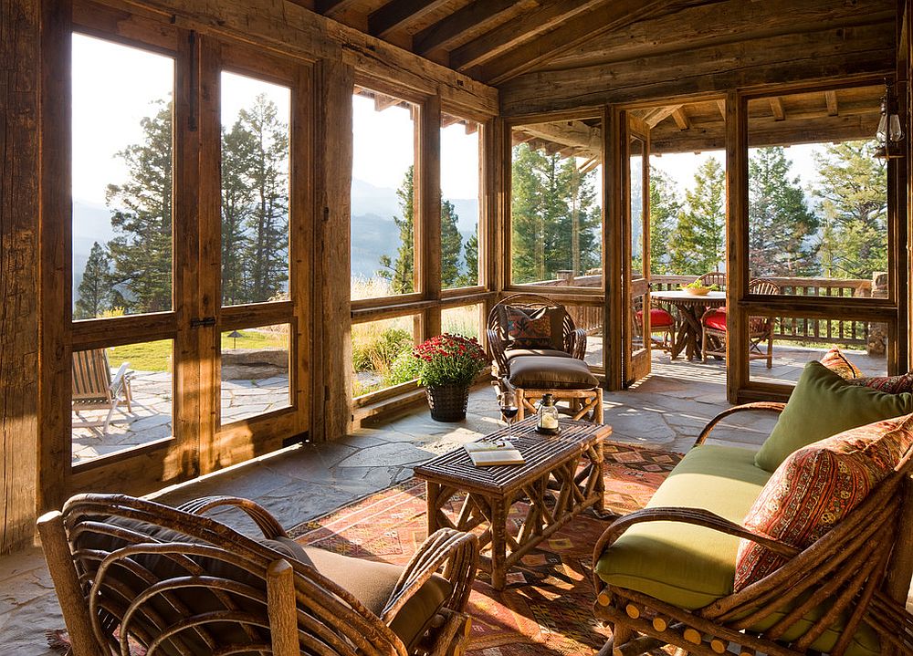 Rustic sunroom that flows into the deck acts as a bridge between the interior and the outdoors