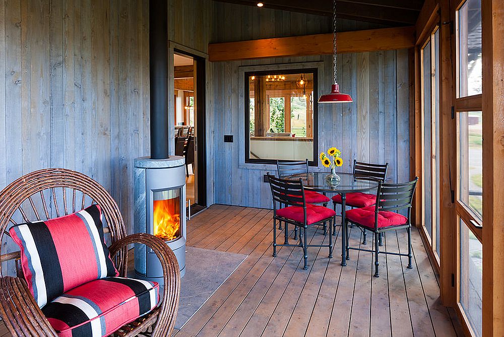 Screened porch sunroom with fireplace and colorful decor