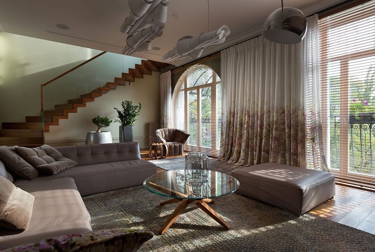 Sectional in gray, unique pendants and lovely natural lighting create a fabulous living space