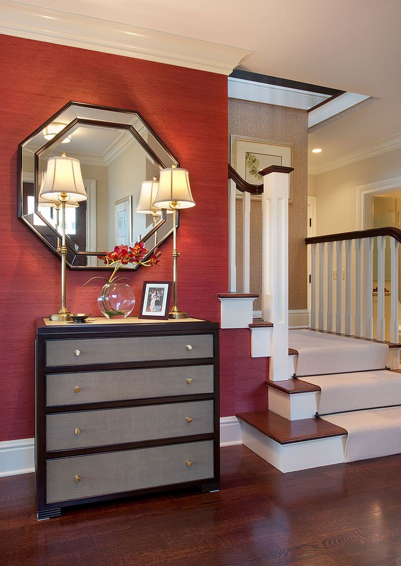 Simple and elegant entry with red grasscloth wallcovering, dashing mirror and a lovely console