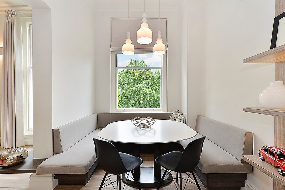 Sleek built-in banquette seating in neutral hues is perfect for the Scandinavian dining nook