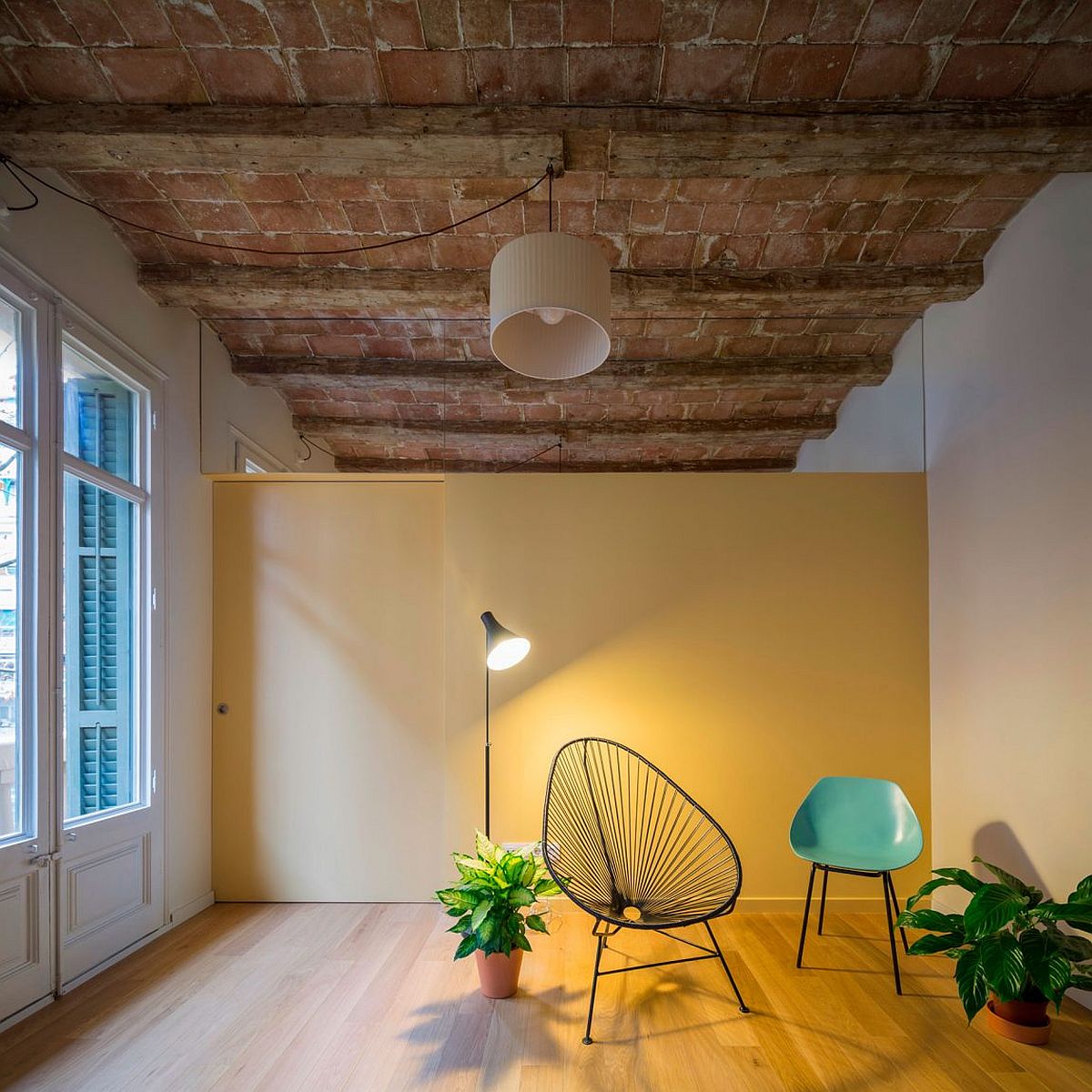 Sliding door painted in the same color as the wall separates the living area from the bedroom