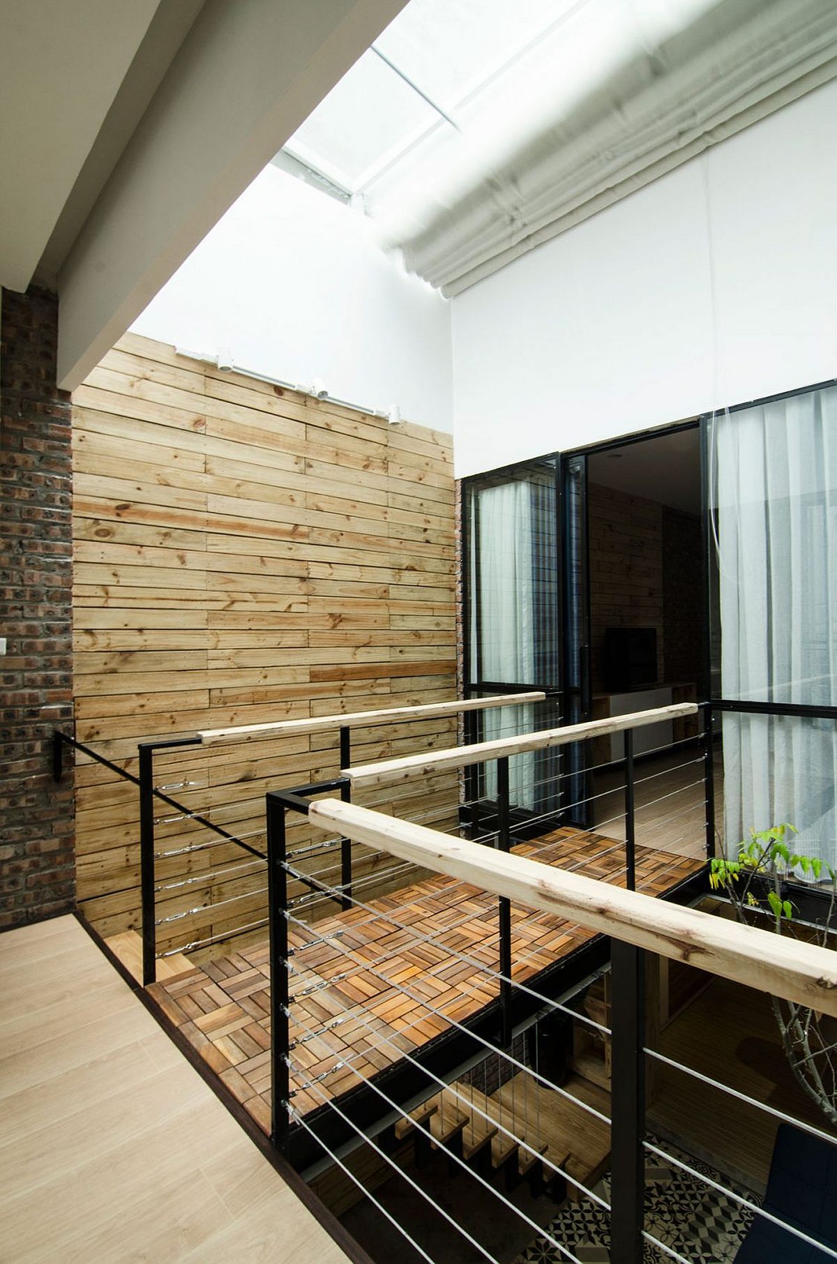 Small bridge connects the master bedroom with the home office on the second level