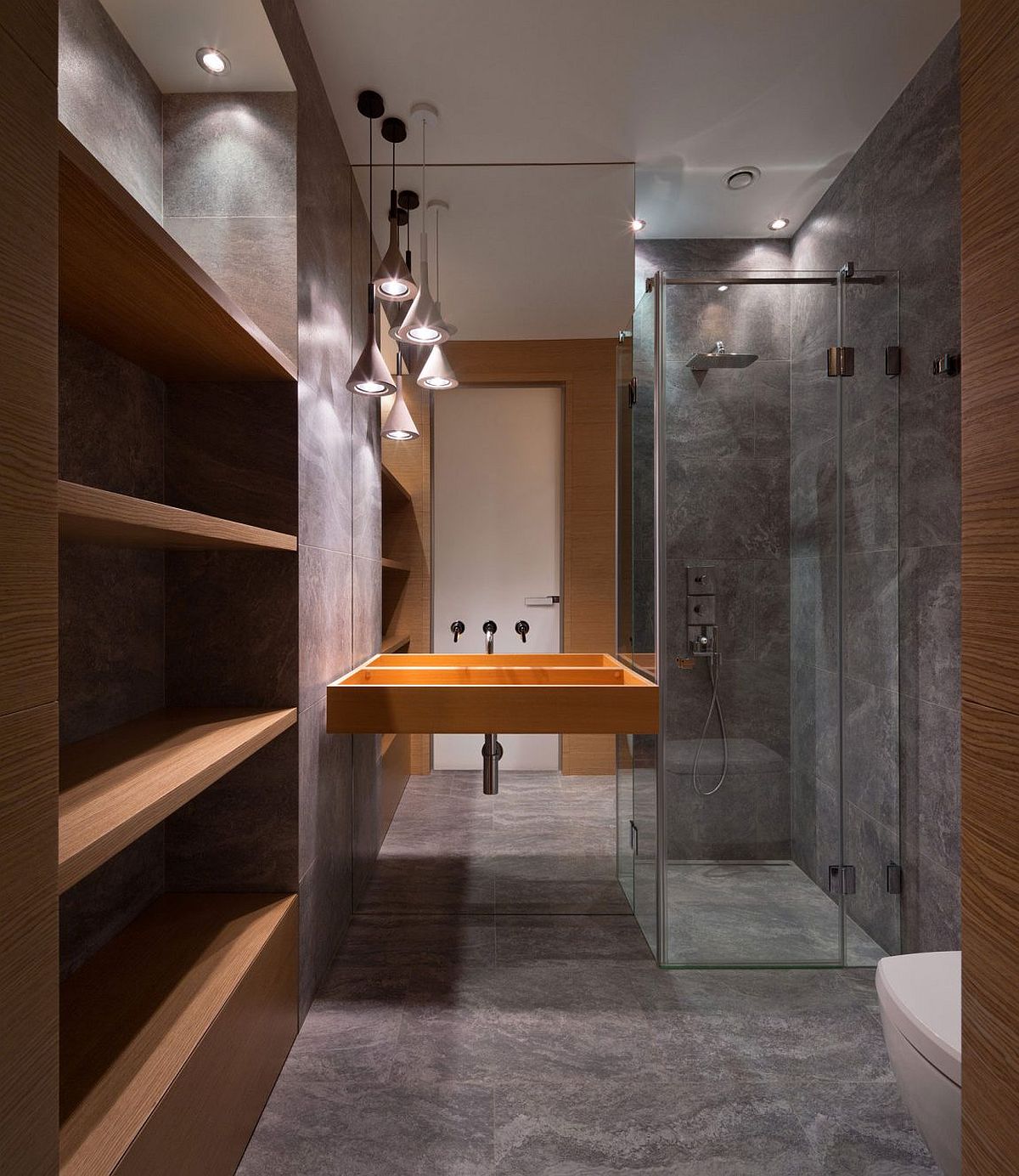 Smart modern abthroom with textured walls and glass shower area