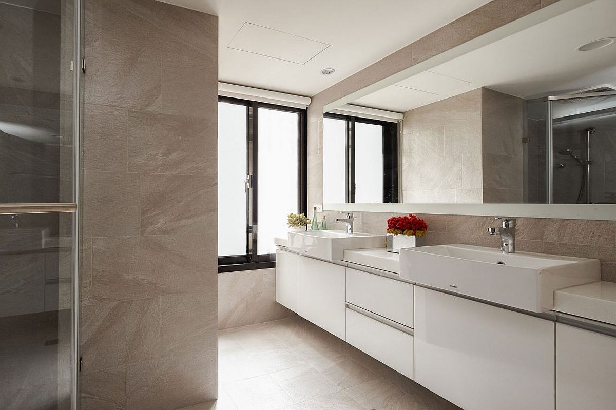 Spacious bathroom with large floating vanity in white